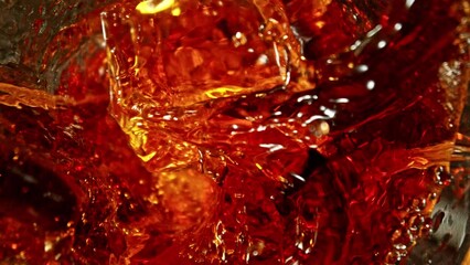 Wall Mural - Super Slow Motion of Falling Ice Cube into Cola Drink. Filmed on High Speed Cinema Camera, 1000 fps, Camera Tracking the Target.