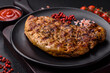 Delicious juicy pork steak with salt, spices and herbs