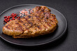 Delicious juicy pork steak with salt, spices and herbs