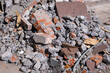 broken bricks, pieces of concrete and granite tiles on the ground after demolition of a building