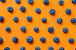 Fresh Blueberries Top View on Vibrant Orange Background with Copy Space, Flat Lay Food Photography Concept