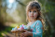 Young girl holding basket of colorful Easter eggs in forest clearing with trees in background