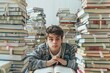 © Studium L&M - Teen boy studying hard surrounded by towering piles of books.