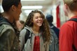 © Iftikhar alam - Group of students standing, laughing, and chatting in a circle outdoors, A group of students laughing and chatting in the hallway