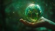 The hand hold a miniature glass Earth on a green background. Ecology concept. Earth Day.