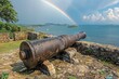 Historic Old Cannon Overlooking a Tropical Bay with Rainbow and Islands