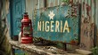 Vintage Rusty Sign Reading Nigeria With Star and Red Lantern Against a Corrugated Iron Background