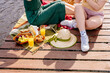 Mother and child enjoy a picnic by the dock with food and fruit on tableware