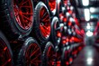 © sukar - car tire shop with high-end sports rims stacked on top of each other in red and black.