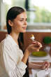 Happy Couple Enjoying Romantic Dinner at Home Woman Smiling in Ecstasy While Indulging in Delicious Cake on a Stylish Dining Table The Table is Set for a Trendy Valentine's Day Date, with Elegant