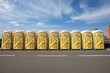 A row of yellow portable toilets lined up on the side of a road for workers, A row of portable toilets lined up for the workers