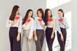 Girls Valentine day happy friends, people in love expression, holding red paper heart showing romantic moment feeling. Loving female group filled with happiness, respect, great interest and pleasure
