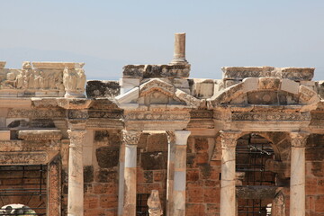 Wall Mural - Antique columns and statues in ancient amphitheater of Hierapolis, Pamukkale, Denizli City, Turkey.