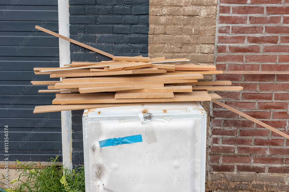 wood waste lies outside on a white metal cupboard