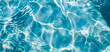close-up of the water of a swimming pool reflecting the waves on a summer day