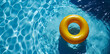 Yellow inflatable ring in a beautiful crystal clear pool