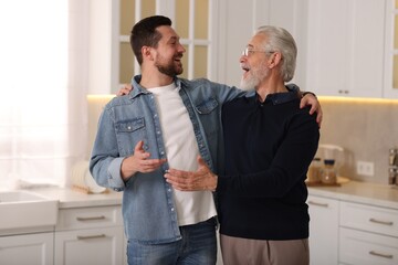 Wall Mural - Happy son and his dad talking at home