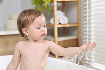 Sticker - Cute little child bathing in tub at home