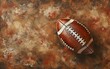 © OLGA - American football with white lacing and stripes on textured brown surface.