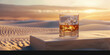 Whiskey or bourbon glass with ice on a square stand with sand dunes in the background.