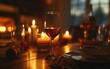 Candlelit dinner table with a warmly glowing wine glass.