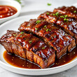 A plate of barbecue ribs with a glossy sauce, placed on a dining table next to a bowl of sauce.