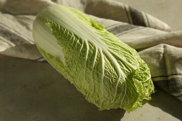 Fresh ripe Chinese cabbage on gray textured table, closeup