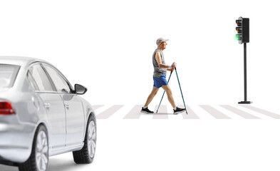 Sticker - Full length profile shot of an elderly man crossing a street with trekking poles