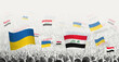 People waving flag of Iraq and Ukraine, symbolizing Iraq solidarity for Ukraine.