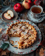 Apple pie on a plate with a cup of tea on a wooden background