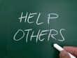 Help others, word text written on chalkboard, motivational inspirational quote