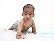 Little Asian baby girl learning to crawl