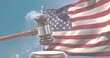 A gavel rests in front of American flag, symbolizing law and justice