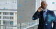 Image of connected icons over african american businessman walking while talking on cellphone