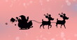 Image of santa in sleigh with reindeer over snow falling