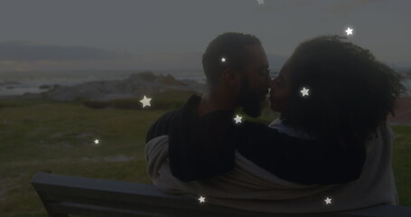 Sticker - Image of stars over diverse couple embracing