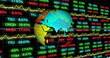 Image of spinning globe over stock market data processing against black background