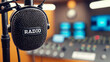 Audio recording studio with professional microphone and sound equipment. Blurred background.