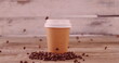 Image of white spots moving over coffee beans falling on takeaway coffee