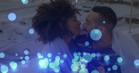 Poster - Image of glowing blue spots falling over african american couple embracing each other at beach