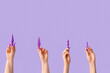 © Pixel-Shot - Female hands with anal plugs and vibrator on lilac background