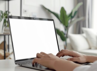 Close up of hands typing on a laptop with a white background display, in a white modern living room background.