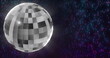 Image of disco ball over light spots on black background