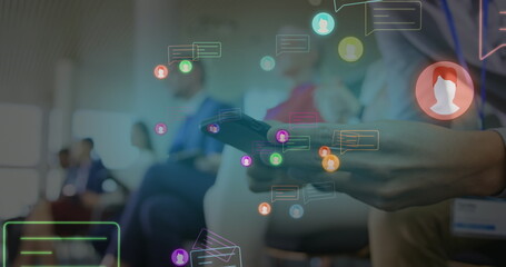 image of neon profile and message icons over mid section of a man using smartphone at office