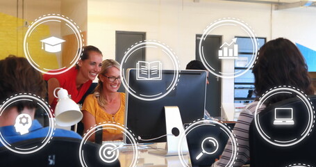 Poster - Image of icons over happy caucasian female coworkers looking into computer and giving high five