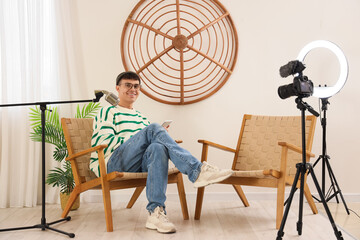 Poster - Young man with tablet computer recording podcast in studio