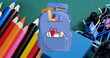 School supplies encircling blue backpack, signaling readiness for learning