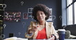 Image of question mark symbol over biracial businesswoman with afro hair writing in book