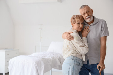 Wall Mural - Mature couple hugging in clinic