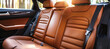 A high-end, luxurious front view of spacious brown leather back passenger seats in a sleek, modern, and stylish luxury car interior, showcasing comfort and elegance.